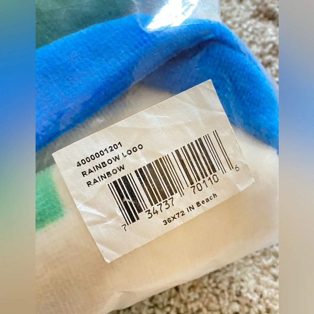 Brand new Lacoste cotton rainbow towel